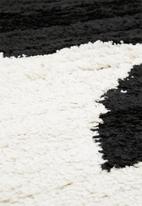 Hertex Fabrics - Balance boulder rug - white & black