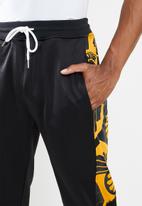 Kaizer Chiefs - Urban Edition - KC pattern collage trackpants - black & yellow