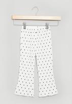 POP CANDY - Flare pants - white & black