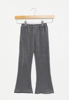 POP CANDY - Flare pants - black & white