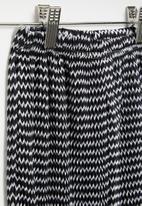POP CANDY - Flare pants - black & white