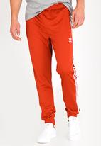 orange sst track pants