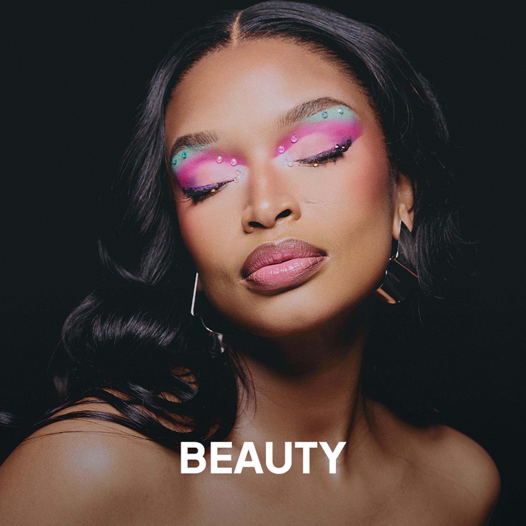 Close-up profile of a Black woman with braided hair wearing large geometric statement earrings against a bright green background, with the word “BEAUTY” overlaid at the bottom.