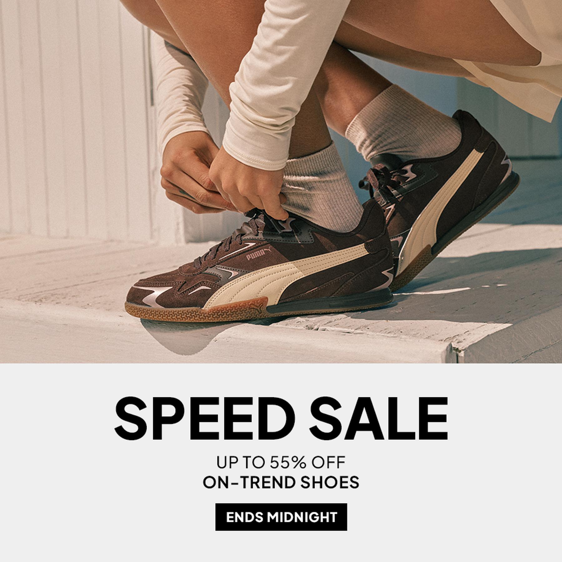 Person tying on a pair of black and cream Puma sneakers, with a promotional banner reading “SPEED SALE,” “UP TO 55% OFF ON-TREND SHOES,” and “ENDS MIDNIGHT.”