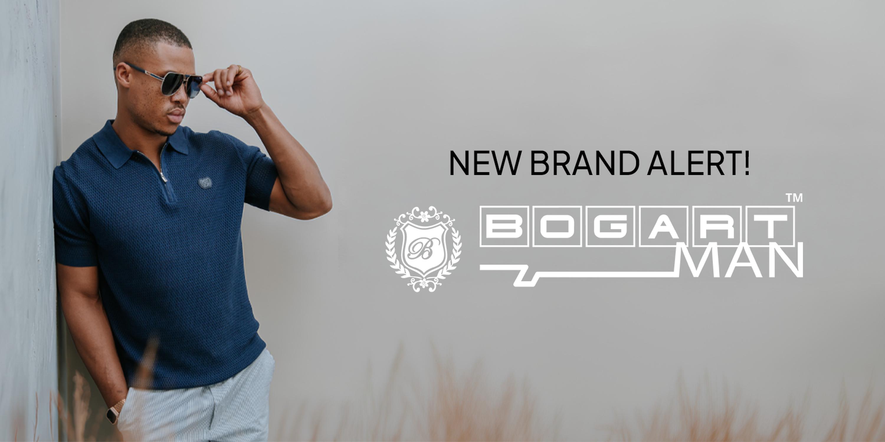 A stylish man in sunglasses and a navy polo shirt stands against a light gray background beside the text “NEW BRAND ALERT!” and the Bogart Man logo, promoting the men’s fashion brand.