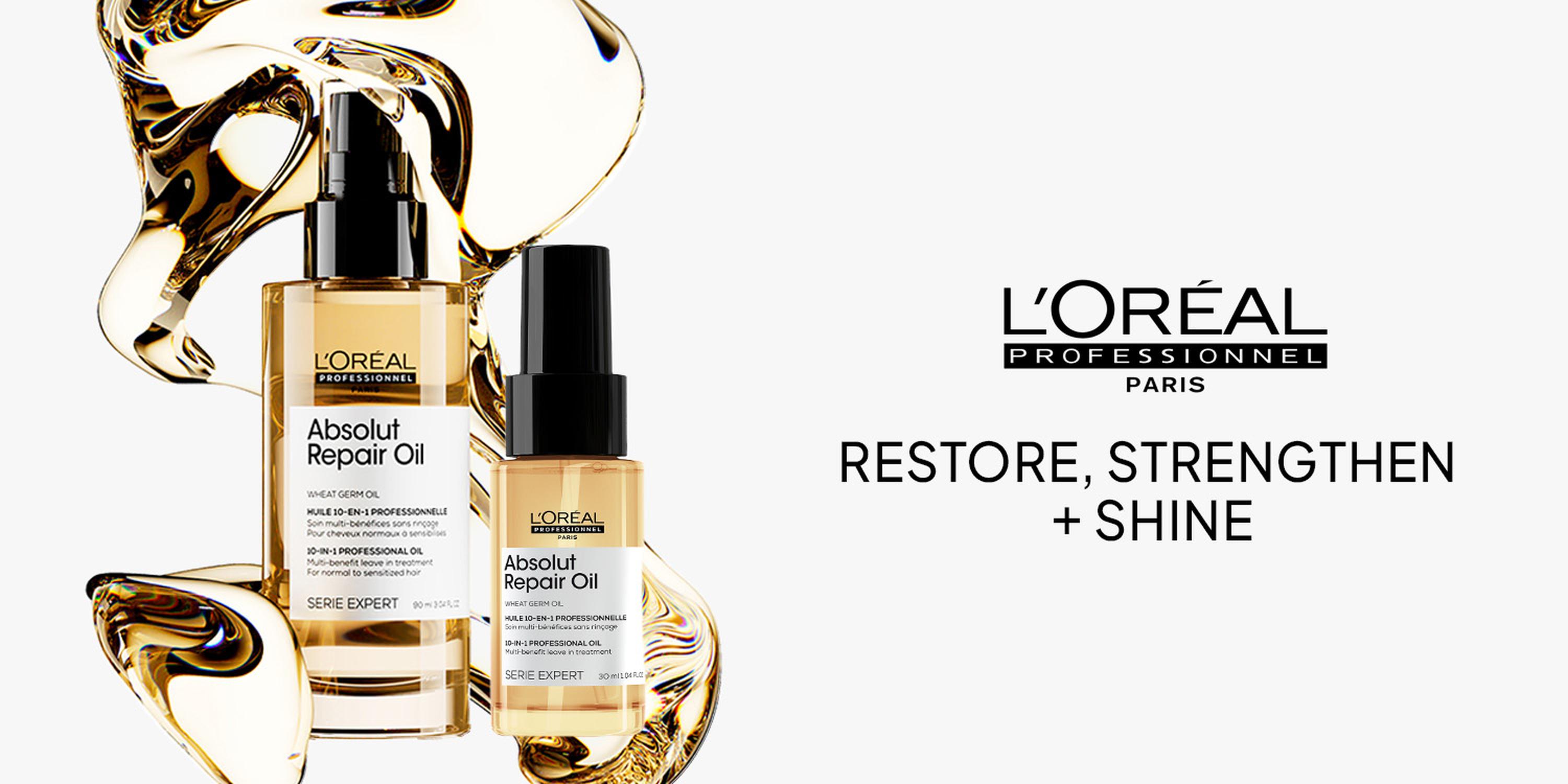 L’Oréal Professionnel Paris Absolut Repair Oil ad on a white background, showing two gold hair oil bottles with swirling amber liquid accents beside the slogan “RESTORE, STRENGTHEN + SHINE.”