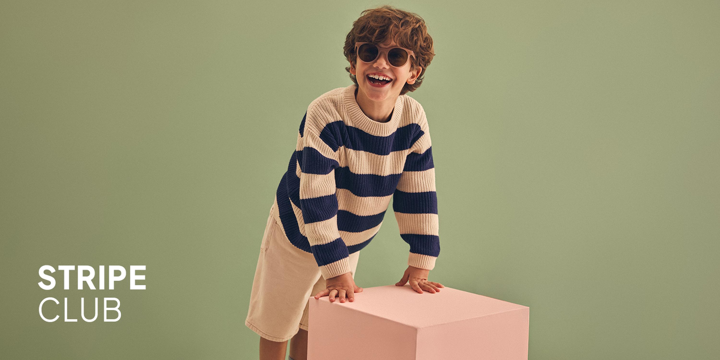Little Layers promotional image featuring a boy and a girl modeling layered kids' outfits.
