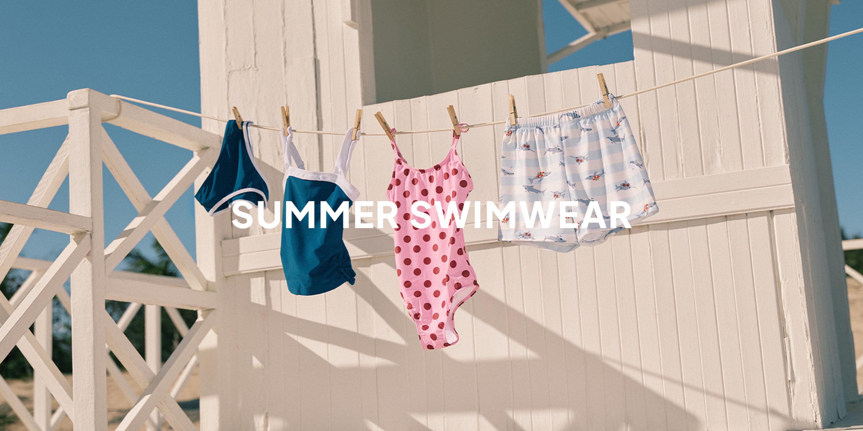 Summer swimwear and baby kids’ suits hanging on a clothesline outside a bright white beach house, with the words “SUMMER SWIMWEAR” overlaid.