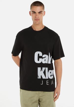 Calvin Klein Jeans Varsity Traveling Logo Long Sleeve Tee in Black