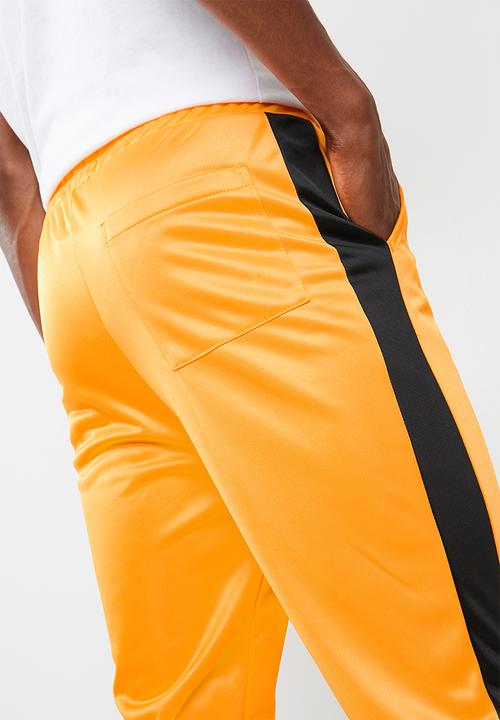 Superbalist - Slim side stripe tricot pant - orange and black