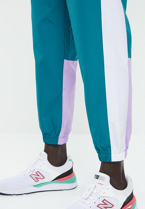 New Balance  - NB athletics windbreaker pant - green & white