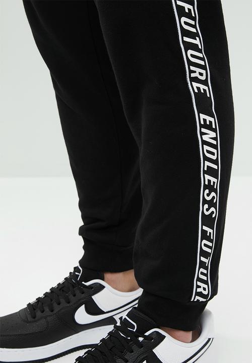 Superbalist - Slim fit printed tape sweat pant - black