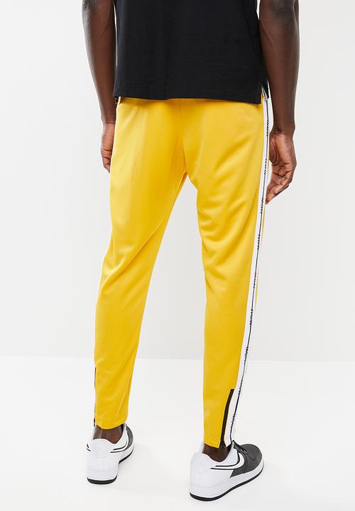 Nike - M nsw nsp track pant - yellow 