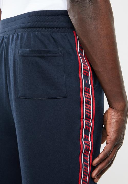 Superbalist - Slim fit printed tape sweatpant - navy & red 