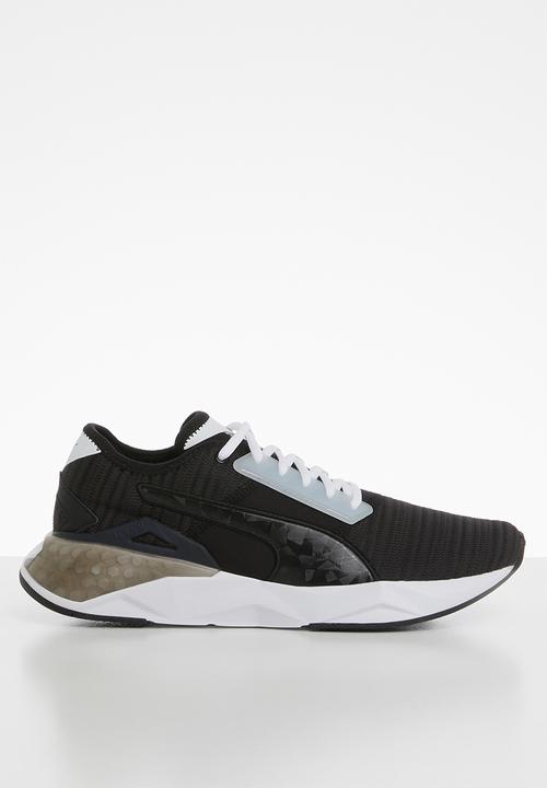 white and black puma trainers