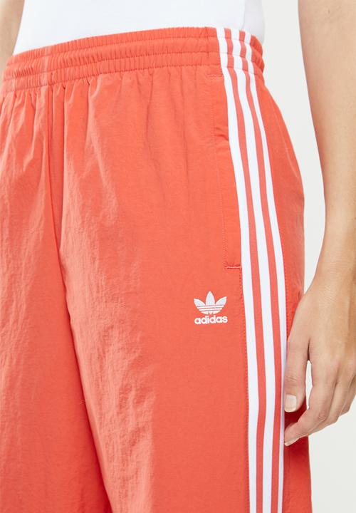 adidas Originals - Adicolour lock up track pants - orange & white