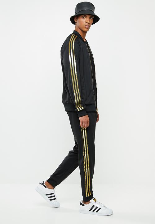 adidas Originals - SST50 track pants 24k - black & gold