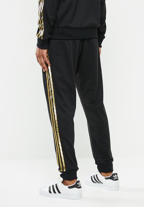 adidas Originals - SST50 track pants 24k - black & gold