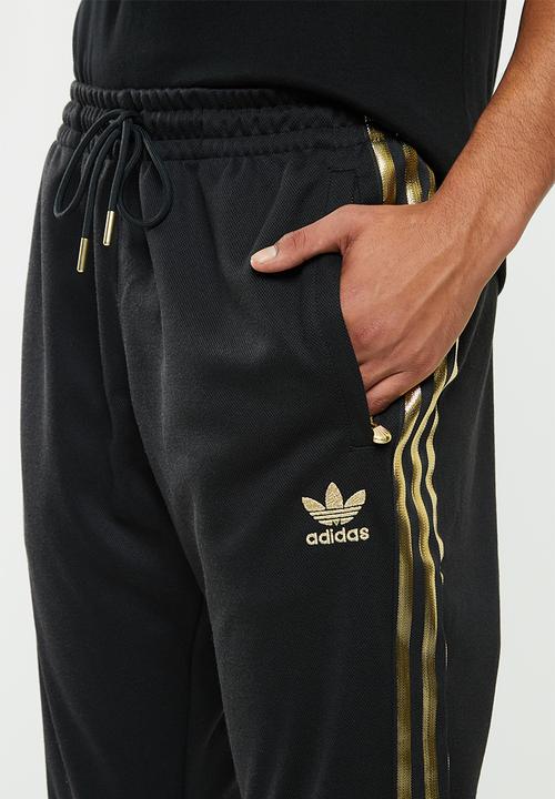 adidas Originals - SST50 track pants 24k - black & gold