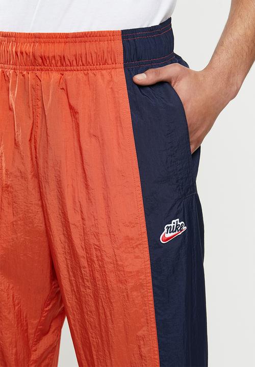 Nike - Nike sportswear he wr+ unld woven pants - orange & navy