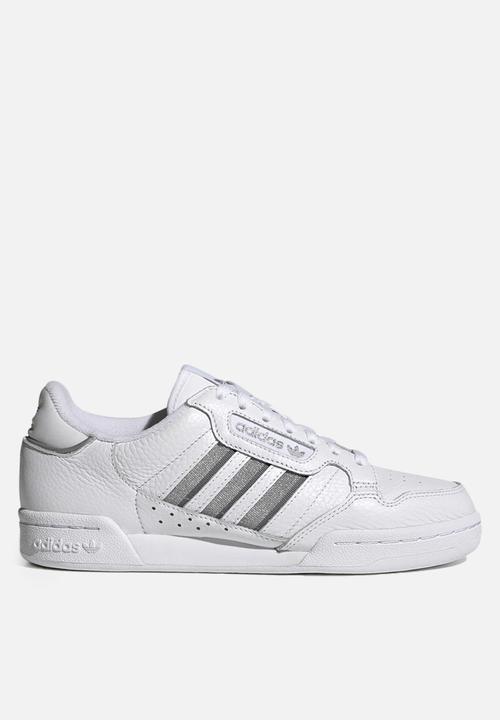 white adidas with silver stripes