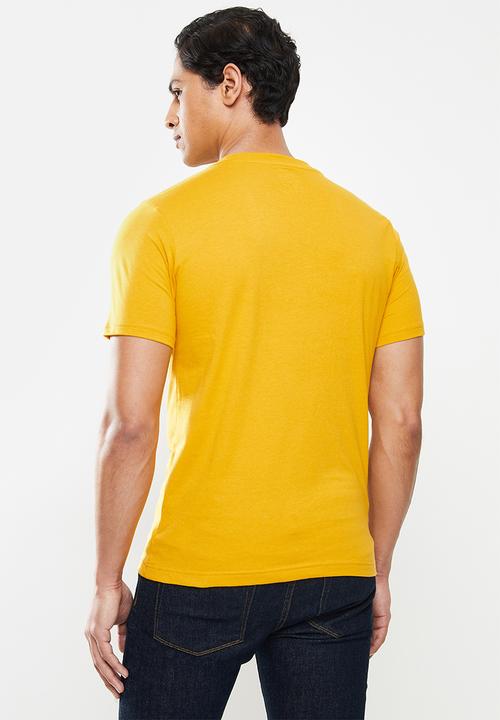 New Balance  - Nb classics graphic tee - varsity gold