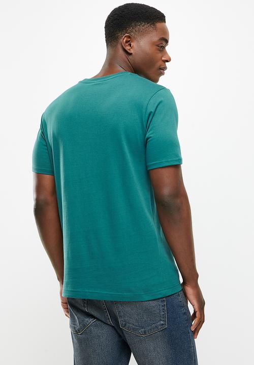 New Balance  - Nb athletics higher learning logo tee - mountain teal