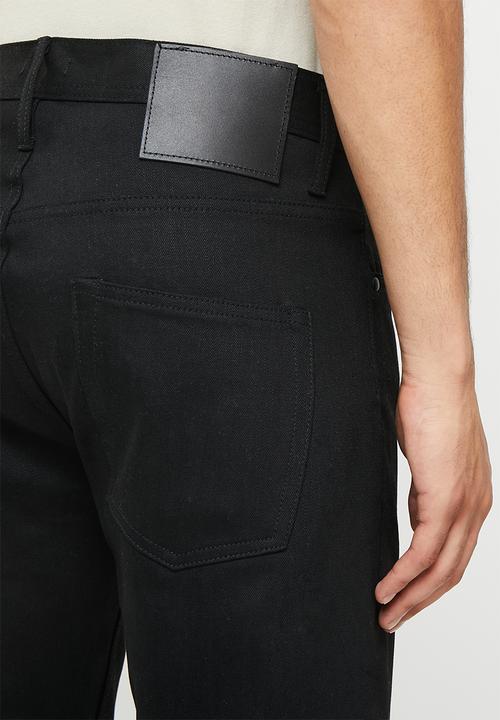 THE UNBRANDED BRAND - Relaxed tapered fit 11 oz solid black stretch selvedge denim