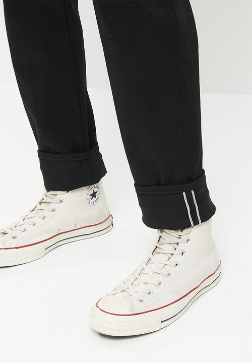THE UNBRANDED BRAND - Relaxed tapered fit 11 oz solid black stretch selvedge denim