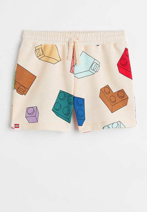 H&M - Patterned sweatshorts - light yellow/lego® collection