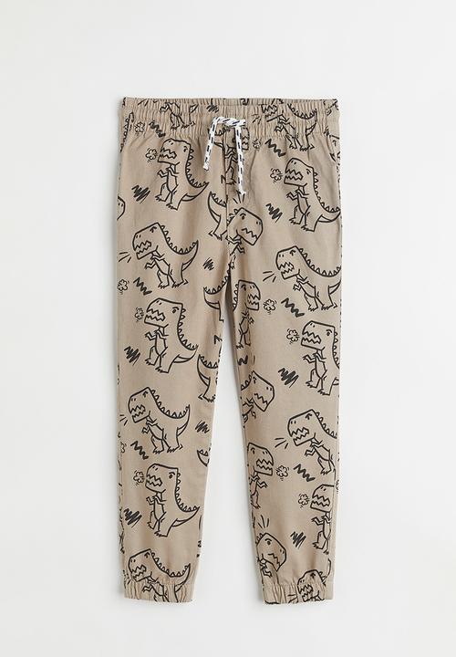 H&M - Relaxed fit joggers - beige/dinosaurs