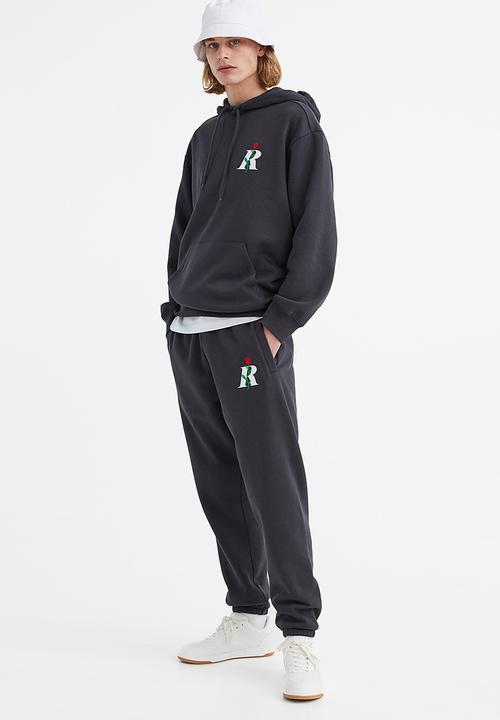 H&M - Regular fit printed sweatpants - dark grey/rose