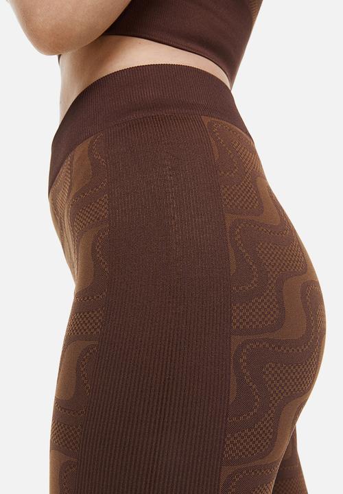 H&M - Seamless sports tights - dark brown/patterned