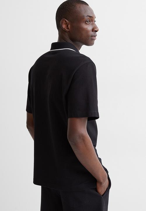 H&M - Regular fit polo shirt - black/arôme