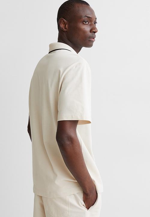 H&M - Regular fit polo shirt - cream/arôme