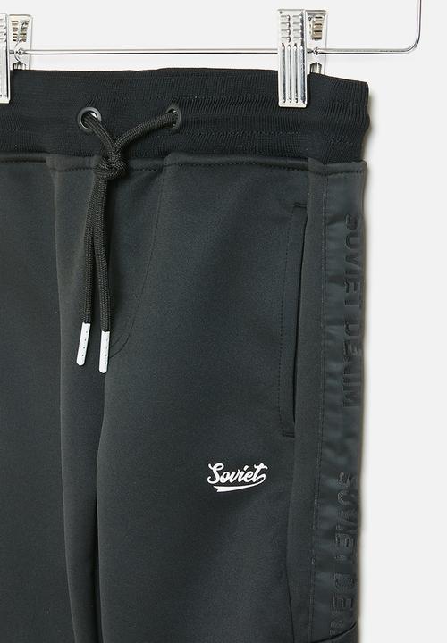 SOVIET - Track pants - black