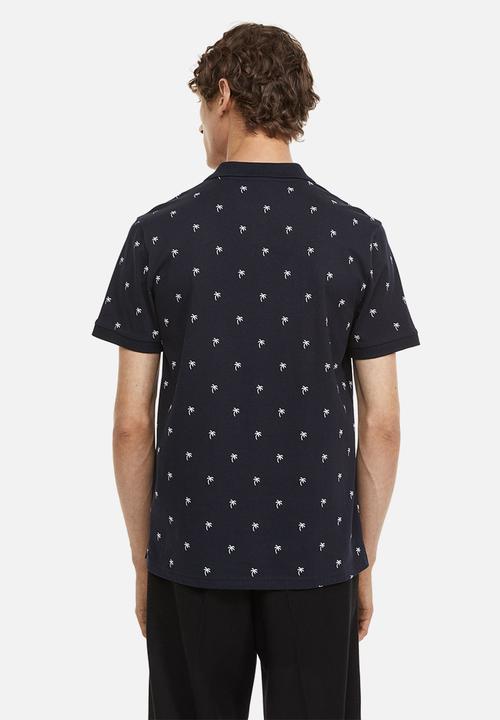 H&M - Slim fit patterned polo shirt - dark blue/palm trees