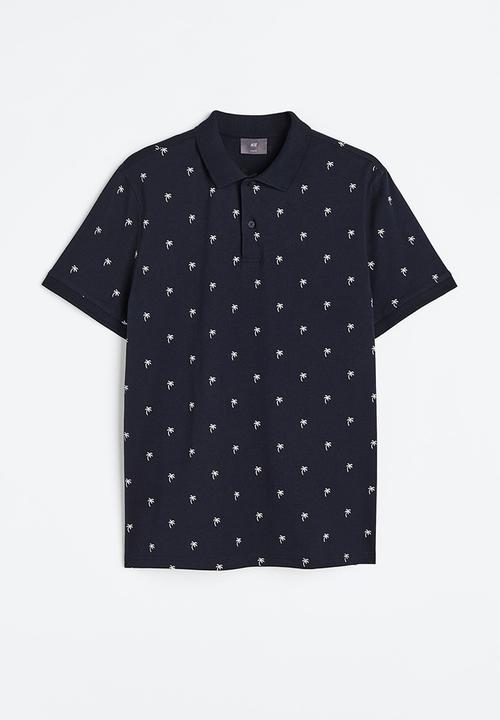 H&M - Slim fit patterned polo shirt - dark blue/palm trees