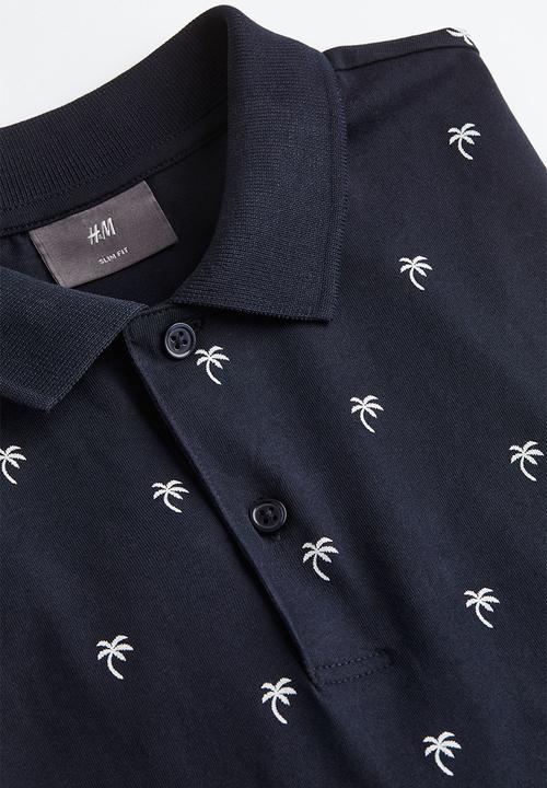 H&M - Slim fit patterned polo shirt - dark blue/palm trees