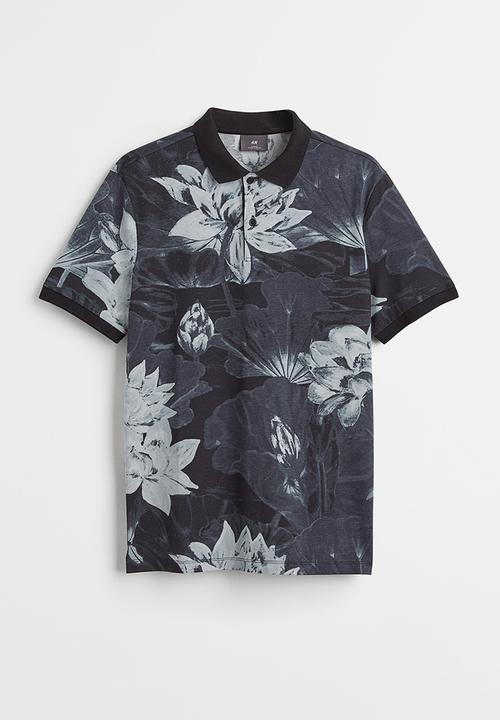H&M - Slim fit patterned polo shirt - black/lotus flowers