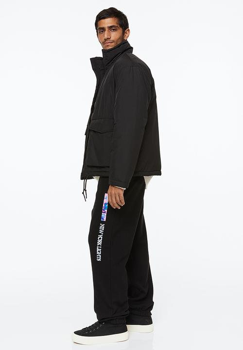 H&M - Relaxed fit sweatpants - black/new york lights