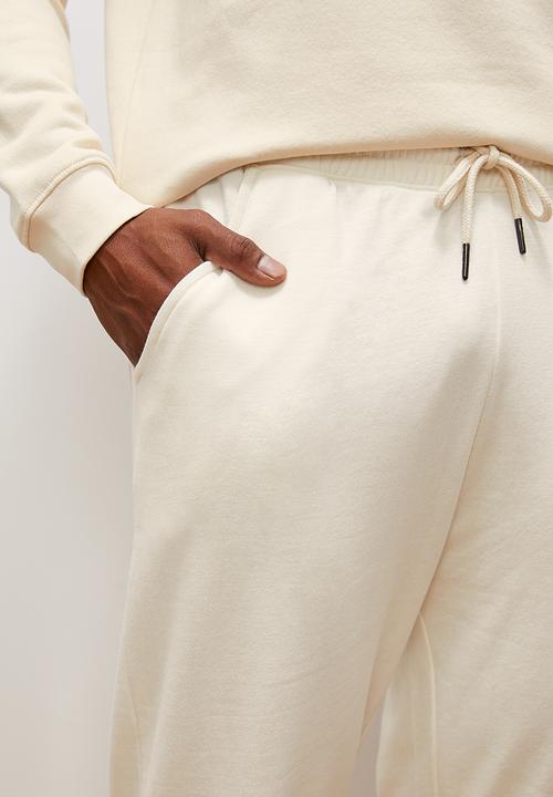 Lark & Crosse - Regular tapered open hem sweatpants - ecru