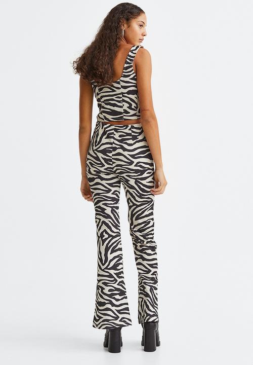 H&M - Glittery flared leggings - black/zebra print