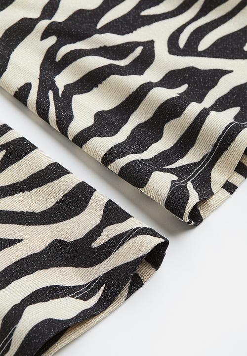 H&M - Glittery flared leggings - black/zebra print