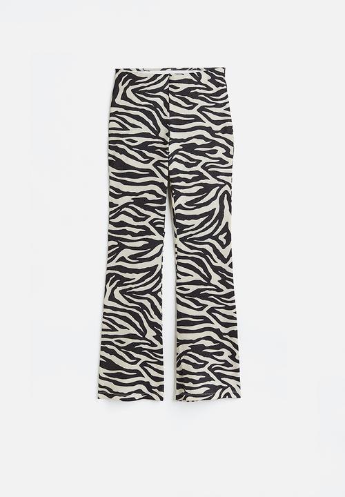 H&M - Glittery flared leggings - black/zebra print