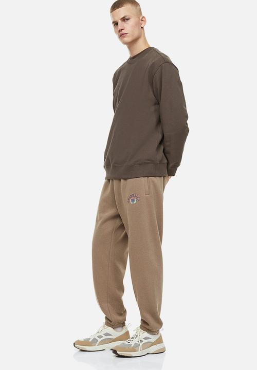 H&M - Relaxed fit printed sweatpants - beige/graduates