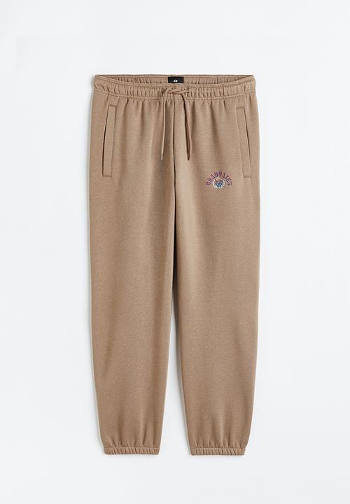 H&M - Relaxed fit printed sweatpants - beige/graduates