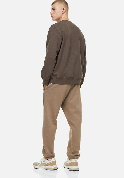 H&M - Relaxed fit printed sweatpants - beige/graduates
