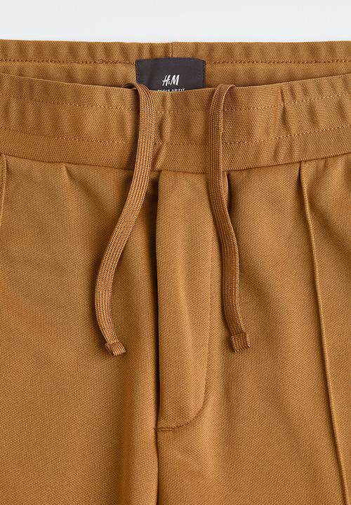 H&M - Regular fit dressy joggers - dark beige/w