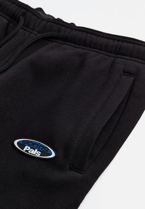 H&M - Relaxed fit printed sweatpants - black/boring pals